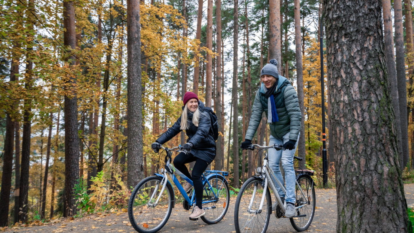 Kaksi ihmistä pyöräilee Seminaarinmäellä