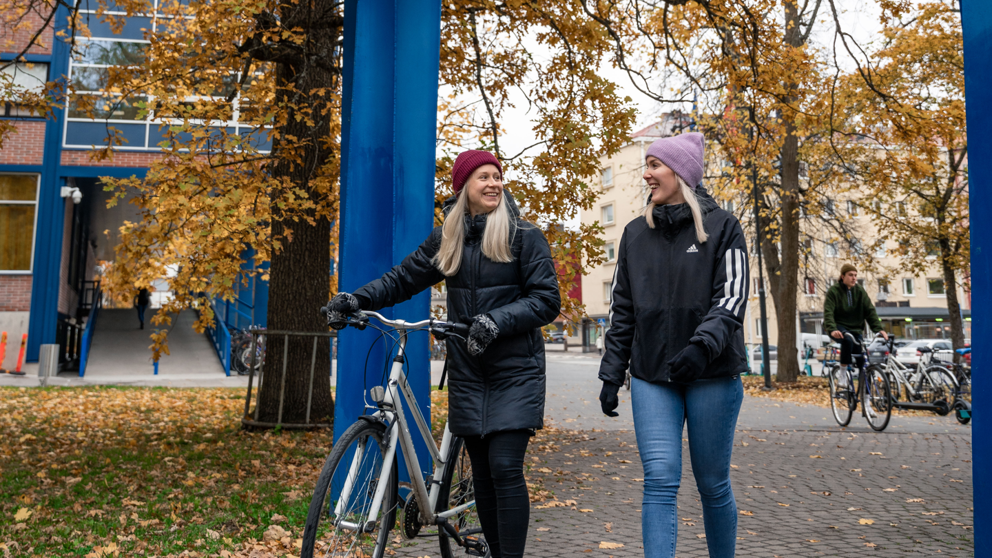 students walking on campus in the autumn