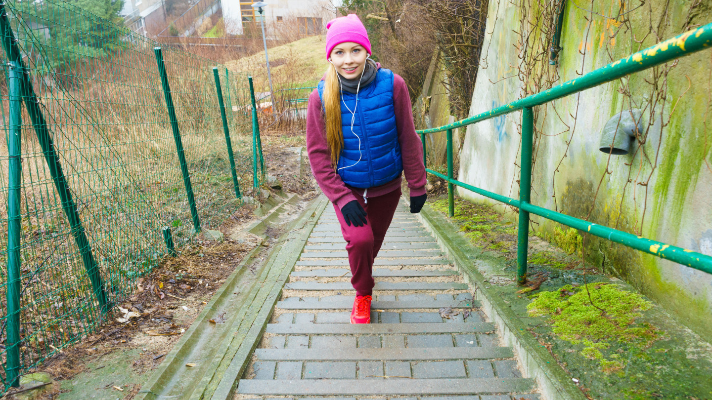 woman exercising on stairs outside during autumn