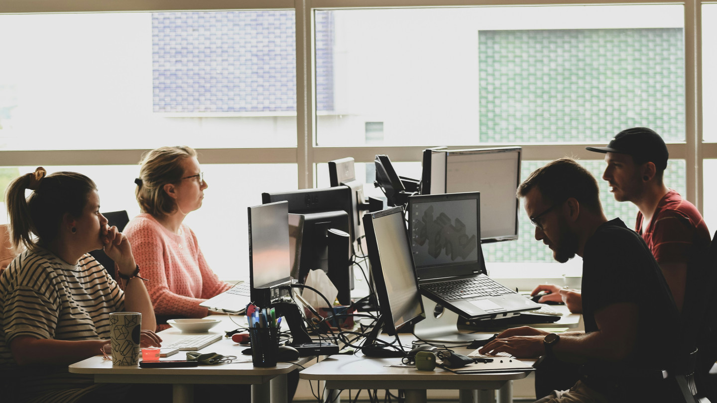 Journalists working in a newsroom.