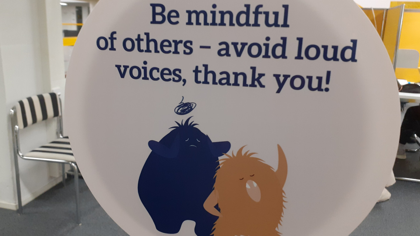 Sign in the University Library asking people to avoid talking loudly. 