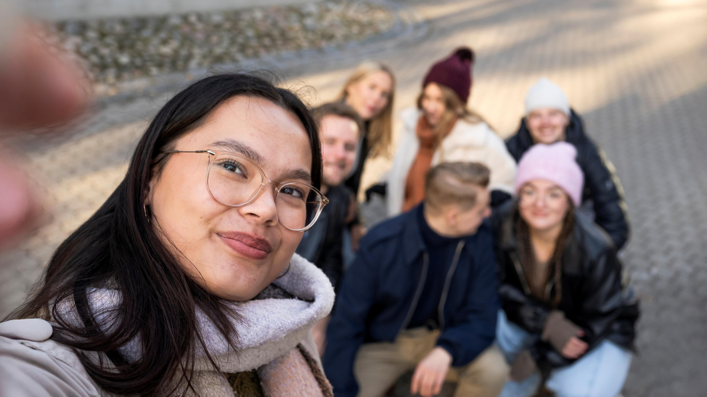 A group of students is taking a photo outside.