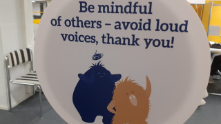 Sign in the University Library asking people to avoid talking loudly. 