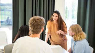 Four students talking to each other.