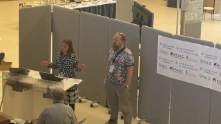 Two researchers presenting their project and findings